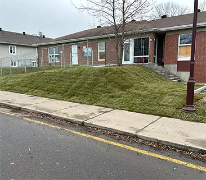 Pose de tourbe sur talus devant immeuble – Aménagement Marosa à Montmagny